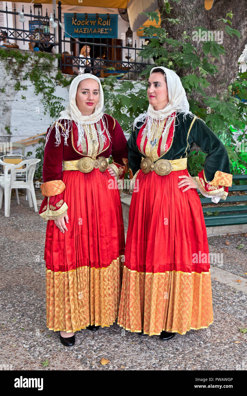 Women from Skiathos wearing traditional costumes of the island. Photo taken at the Old Port of Skiathos town, Skiathos island, Greece. Stock Photo