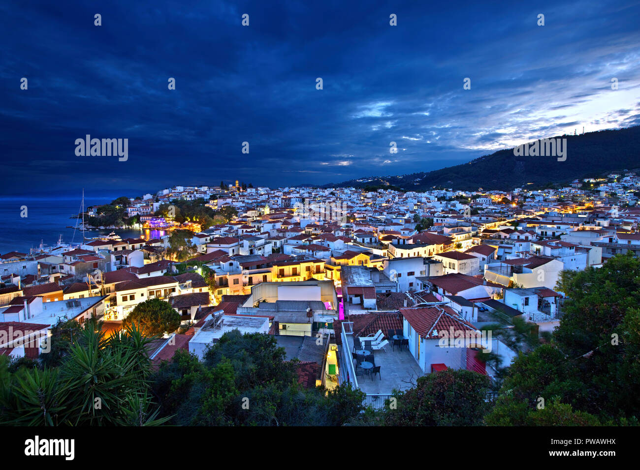 Night view of Skiathos town from the clock tower of Agios Nikolaos church. Skiathos island, Northern Sporades, Magnessia, Thessaly, Greece. Stock Photo