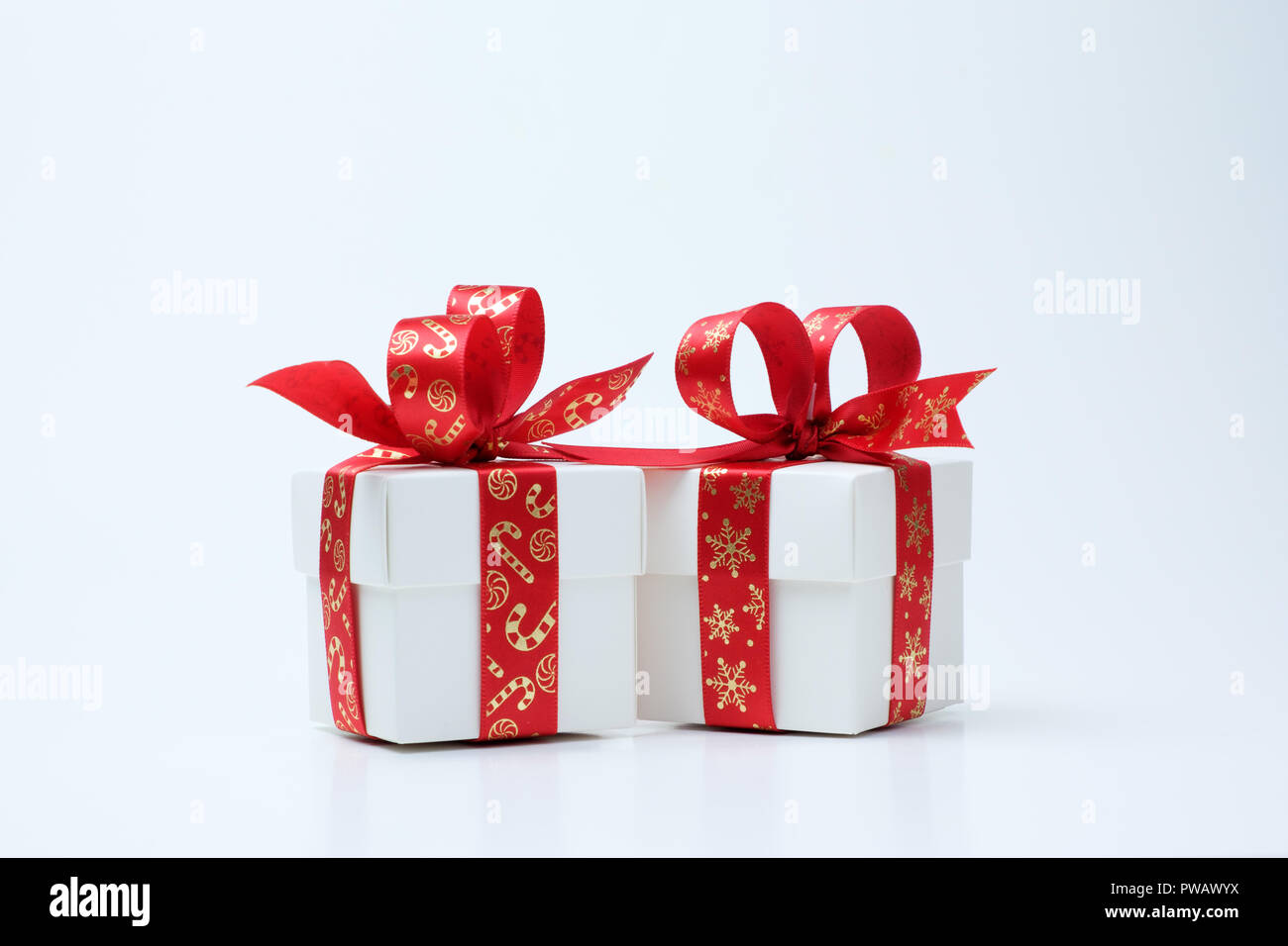 White gift box tied with Christmas theme red ribbon Stock Photo - Alamy