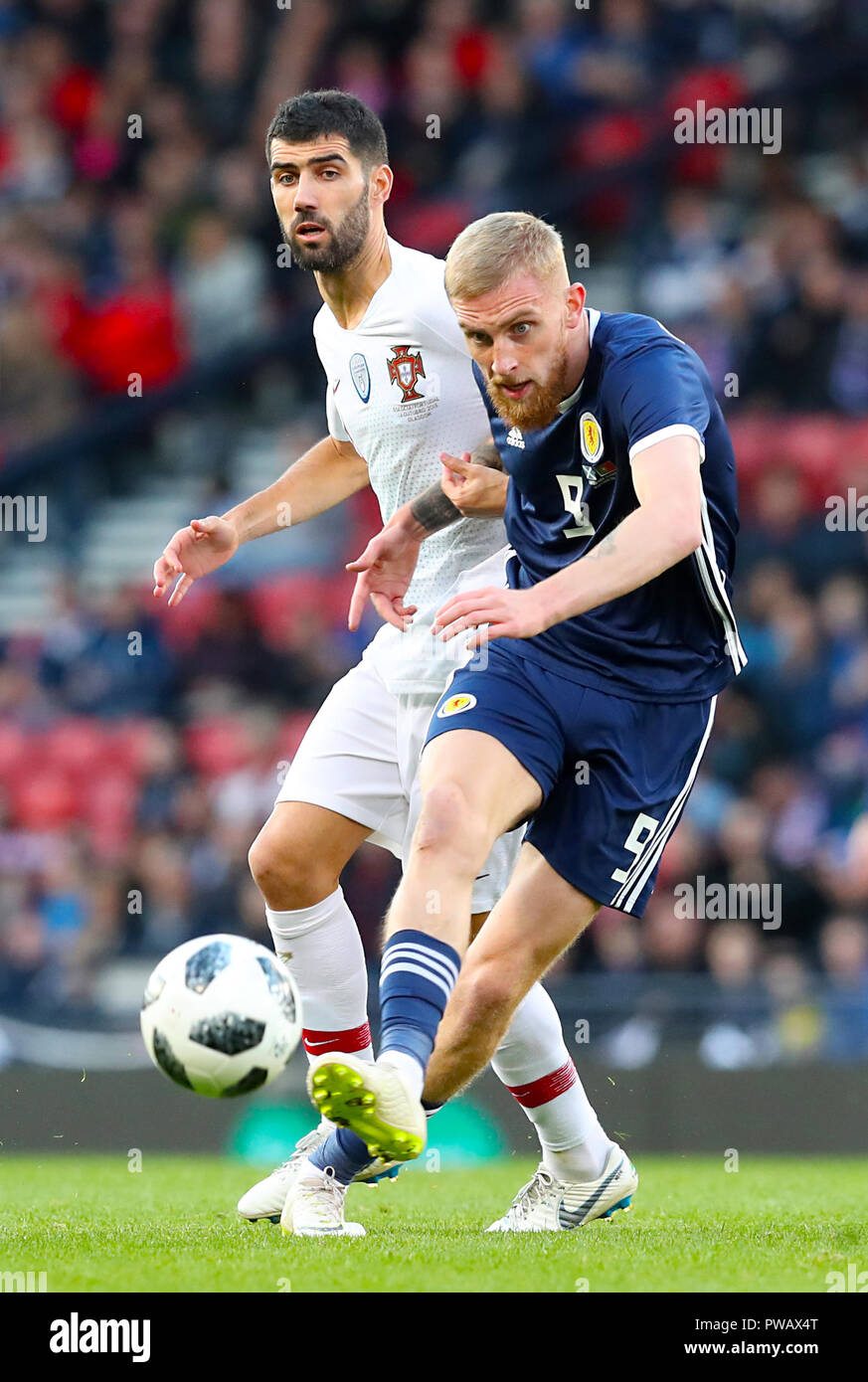 Portugal's Luis Neto (left) and Scotland's Scott McKenna battle for the ball during the International Friendly match at Hampden Park, Glasgow. Stock Photo
