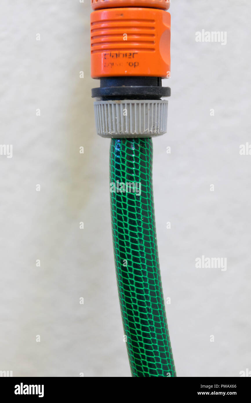 Garden rubber plastic tube tip hose pipe water isolated close up orange