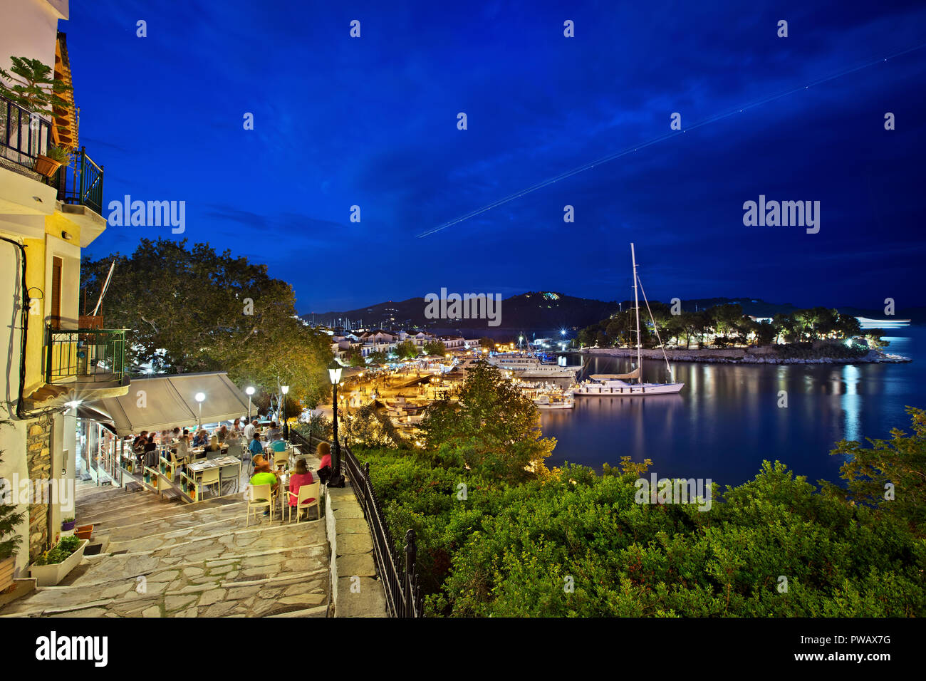 Night view of the Old Port of Skiathos town, Skiathos island, Northern Sporades, Greece. To the right of the photo you can see the Bourtzi castle. Stock Photo