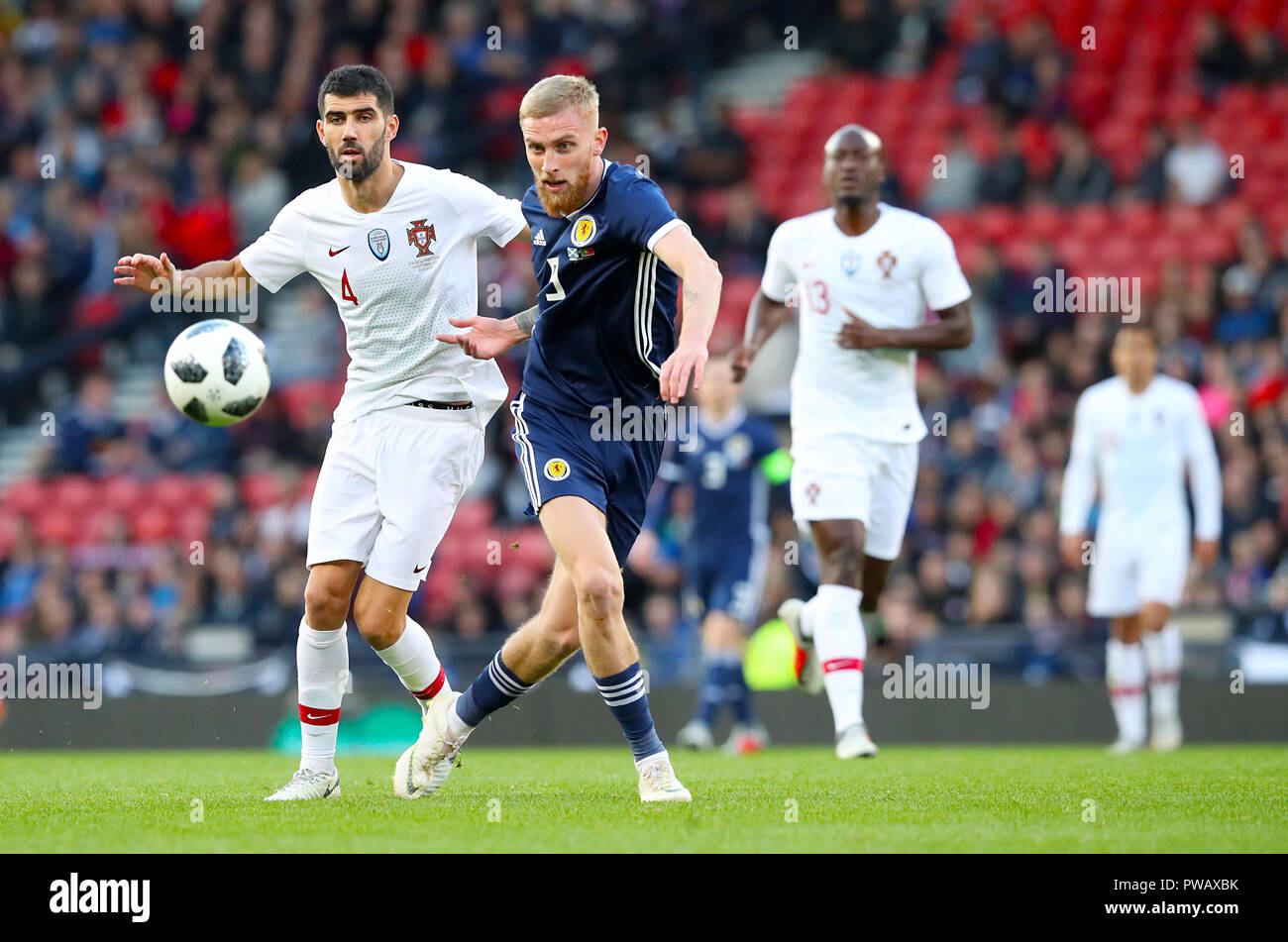 Portugal's Luis Neto (left) and Scotland's Oli McBurnie battle for the ball during the International Friendly match at Hampden Park, Glasgow. Stock Photo