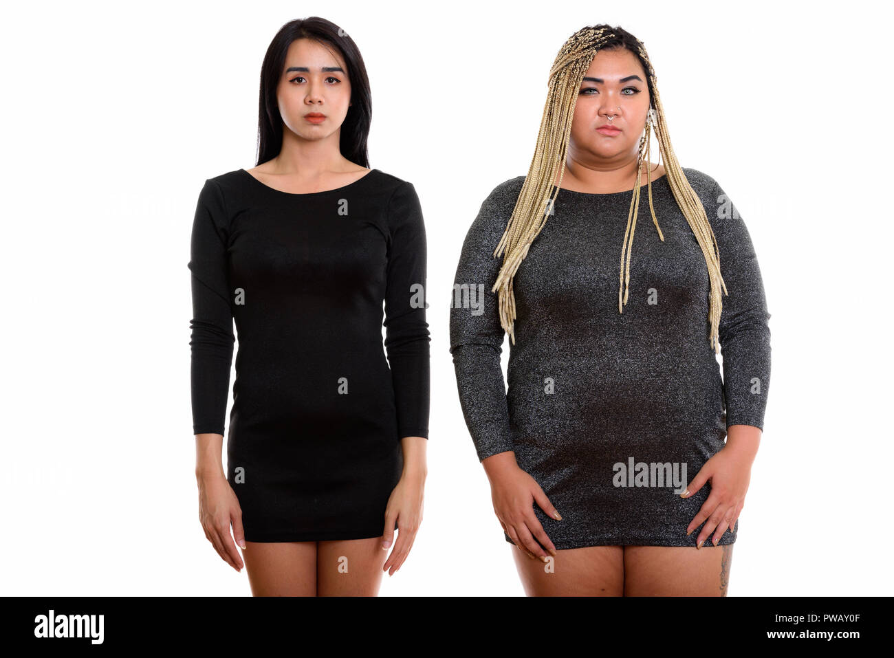 Studio shot of young Asian transgender woman and fat Asian woman Stock Photo