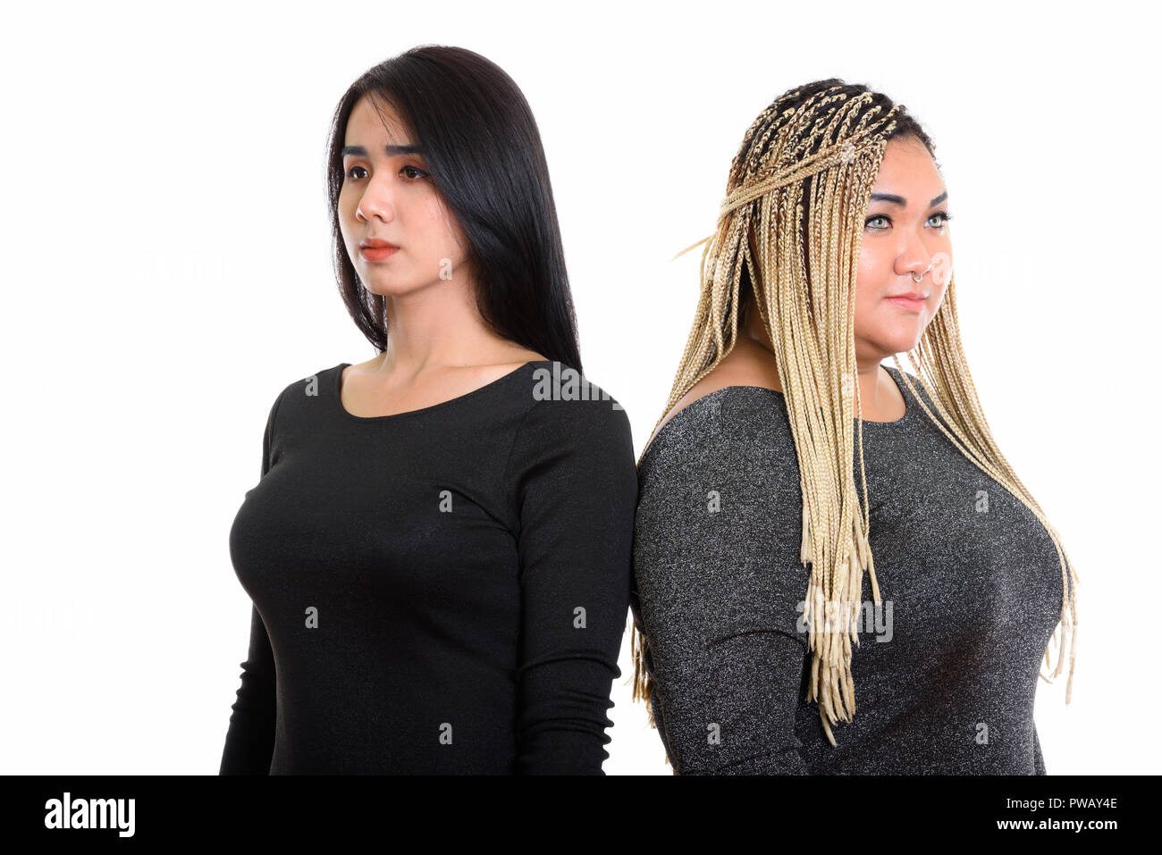 Thoughtful young Asian transgender woman and fat Asian woman loo Stock Photo