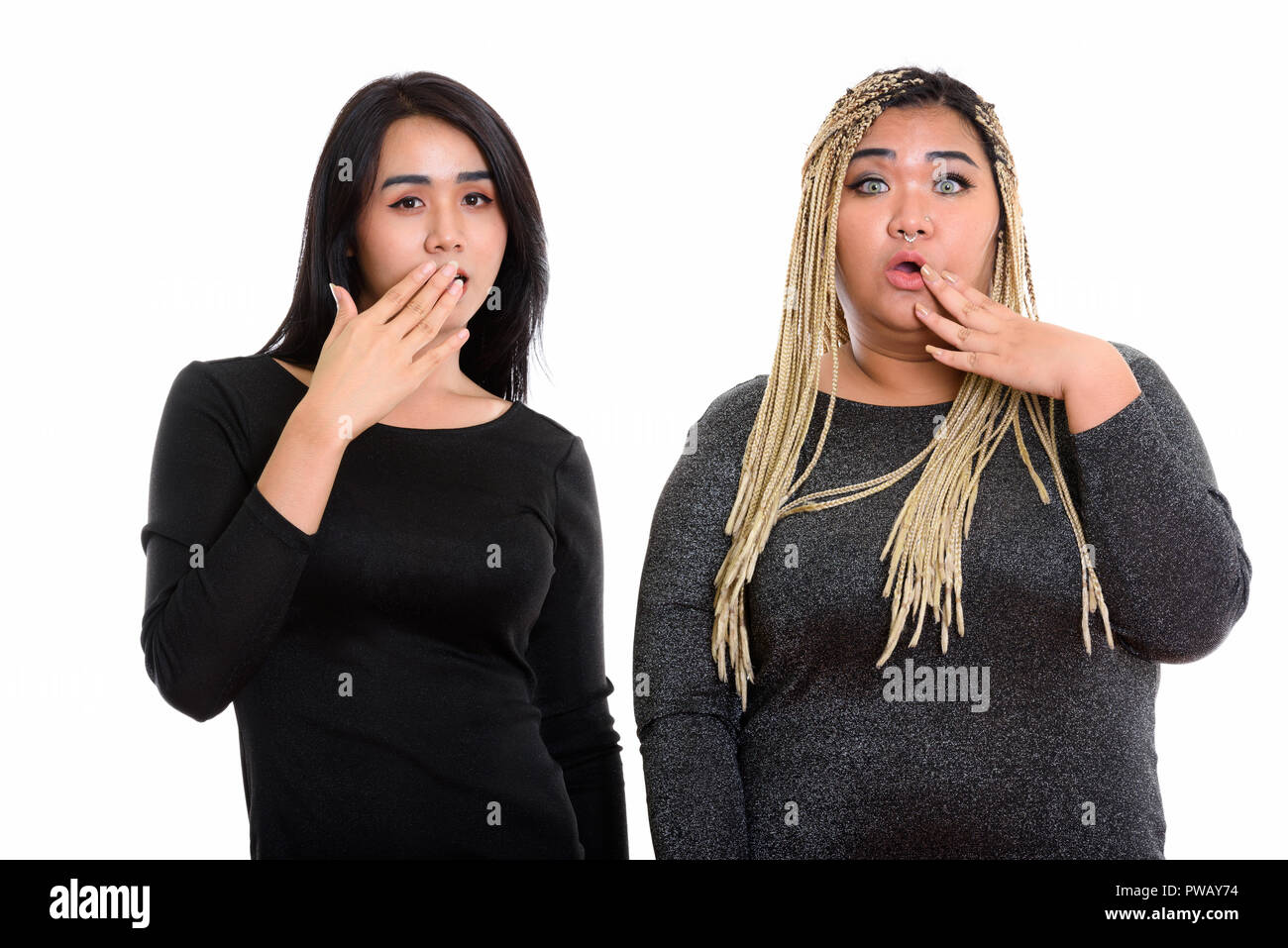 Young Asian transgender woman and fat Asian woman looking shocke Stock Photo