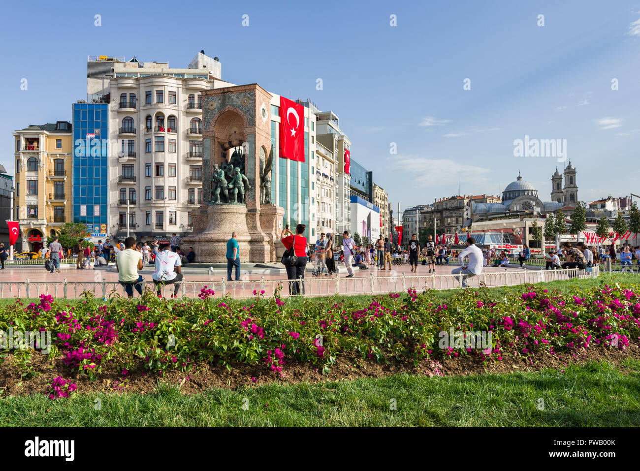 Locals and tourists at the Taksim Square memorial statue on a sunny Spring day, Istanbul, Turkey Stock Photo