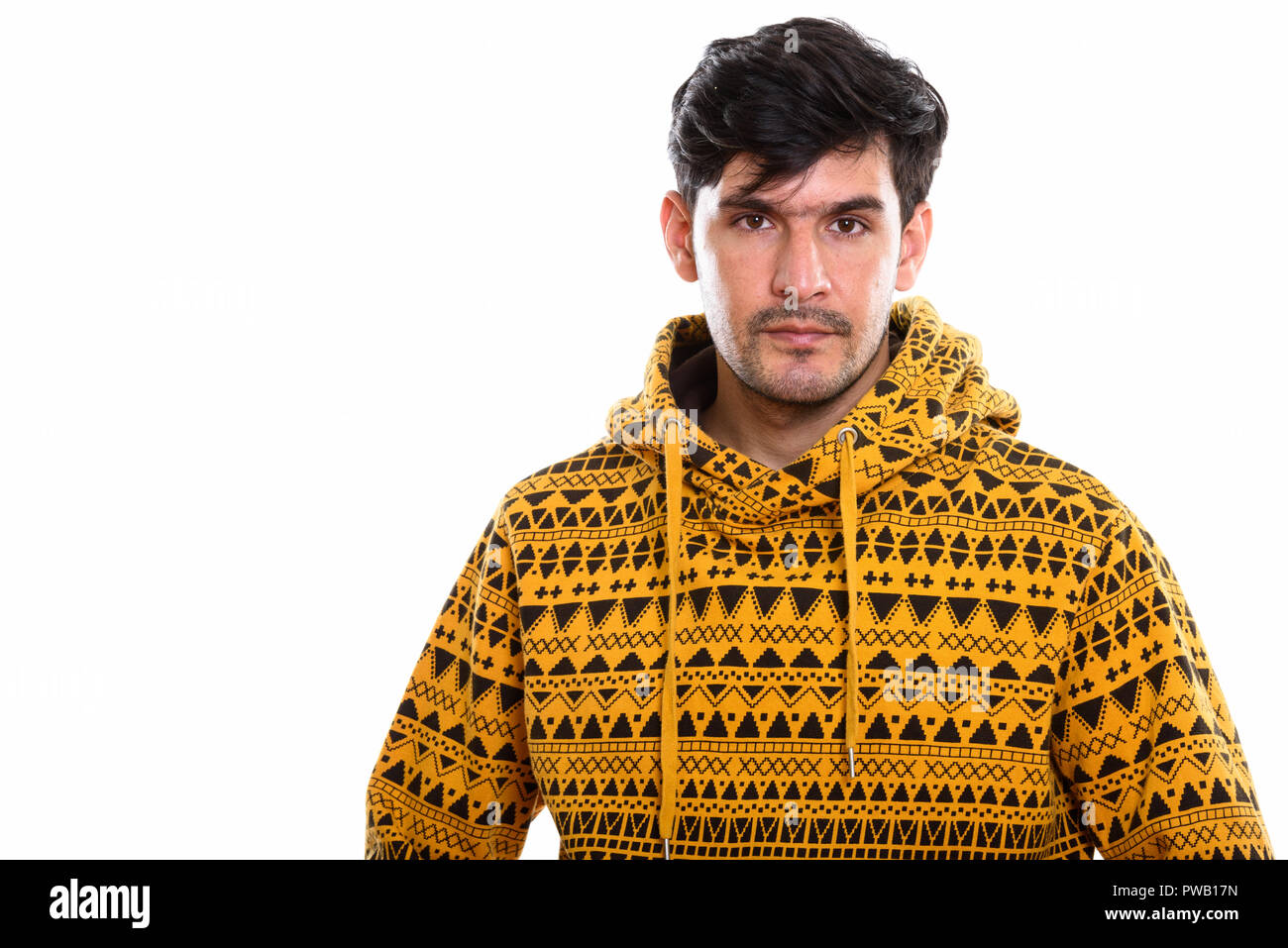 Studio shot of young Persian man wearing hoodie Stock Photo