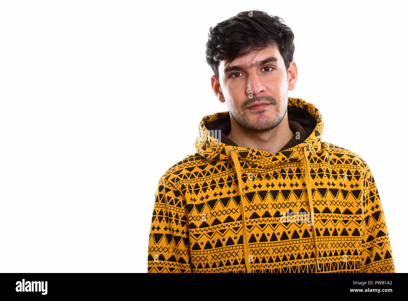 Studio shot of young Persian man wearing hoodie Stock Photo