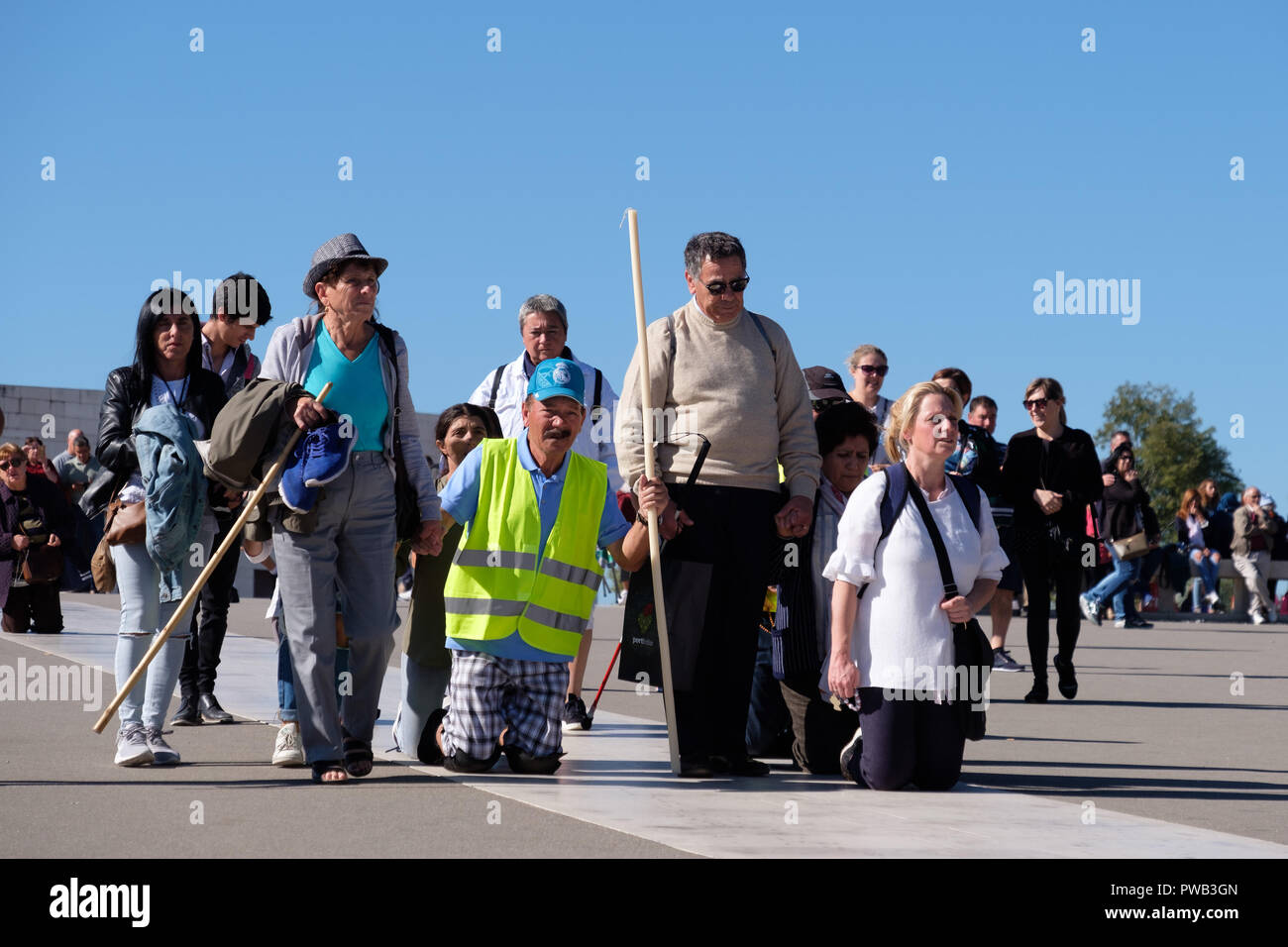 Pilgrims crawling on their knees in penance at the Sanctuary of Our Lady of Fatima, Portugal, Europe Stock Photo