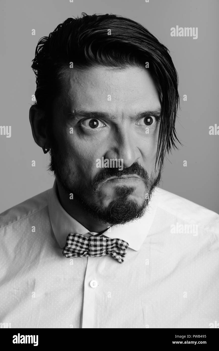 Face of handsome man looking angry in black and white Stock Photo