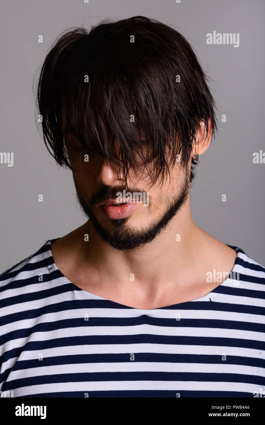 Face of handsome man covering face with hair Stock Photo