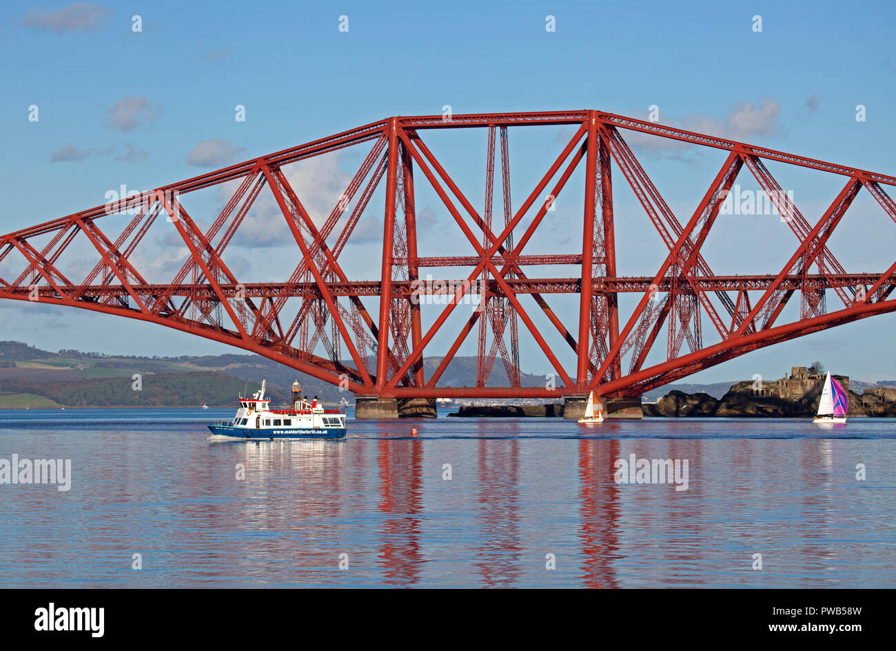 Edinburgh, Scotland, UK. 14 October 2018. UK weather, after a very cloudy cold morning the sun appeared in early afternoon and at 13 degrees it felt warm in the sunshine, not much wind to assist the crews of the small sail boats in the Forth estuary under the Forth Rail Bridge but the tourists on the Maid of the Forth tour boat had a gorgeous afternoon for the sailing. Stock Photo