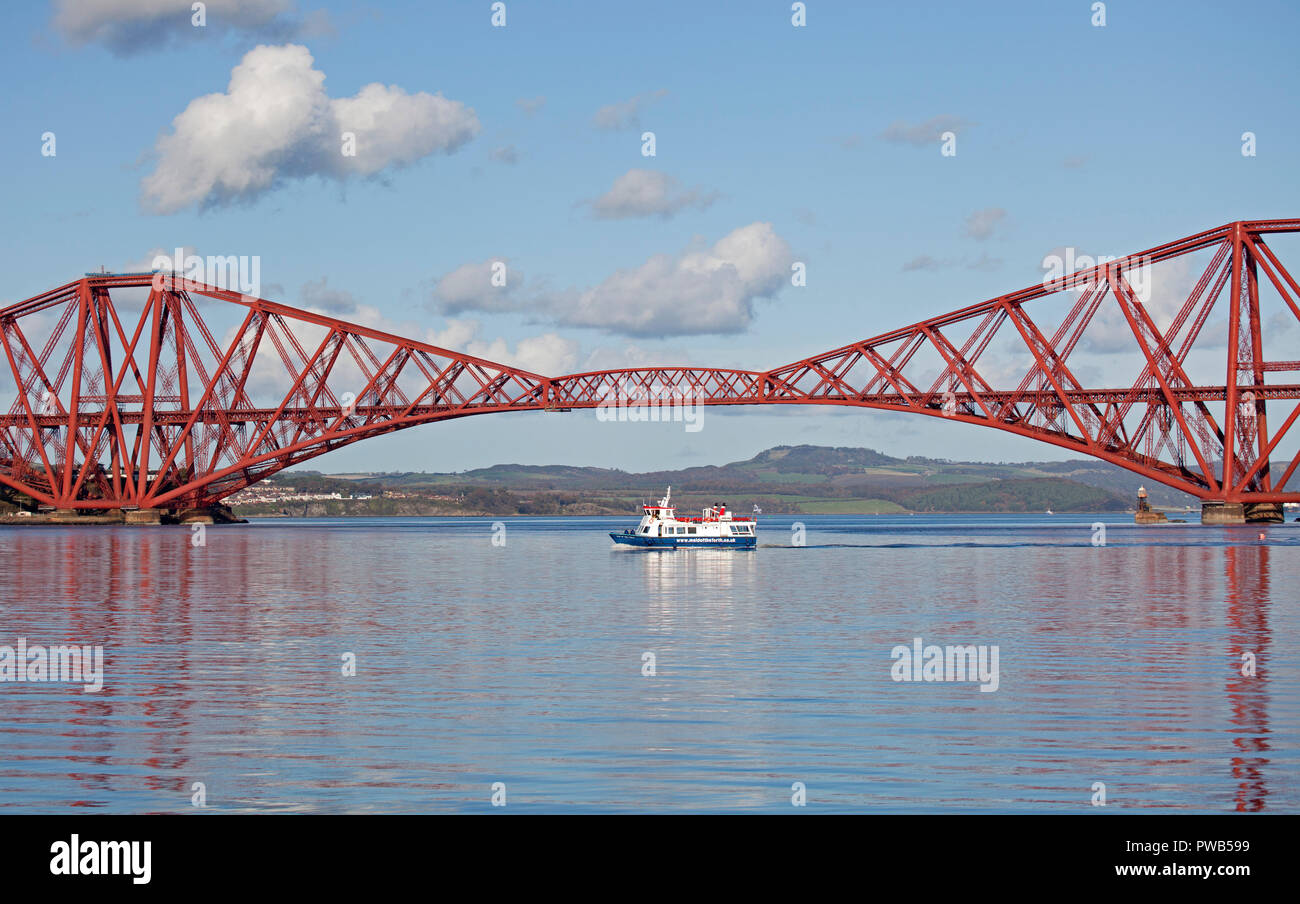 Edinburgh, UK. 14 October 2018. UK weather, after a very cloudy cold morning the sun appeared in early afternoon and at 13 degrees it felt warm in the sunshine,  in the Forth estuary under the Forth Rail Bridge the tourists on the Maid of the Forth tour boat had a gorgeous afternoon for the sailing. Stock Photo