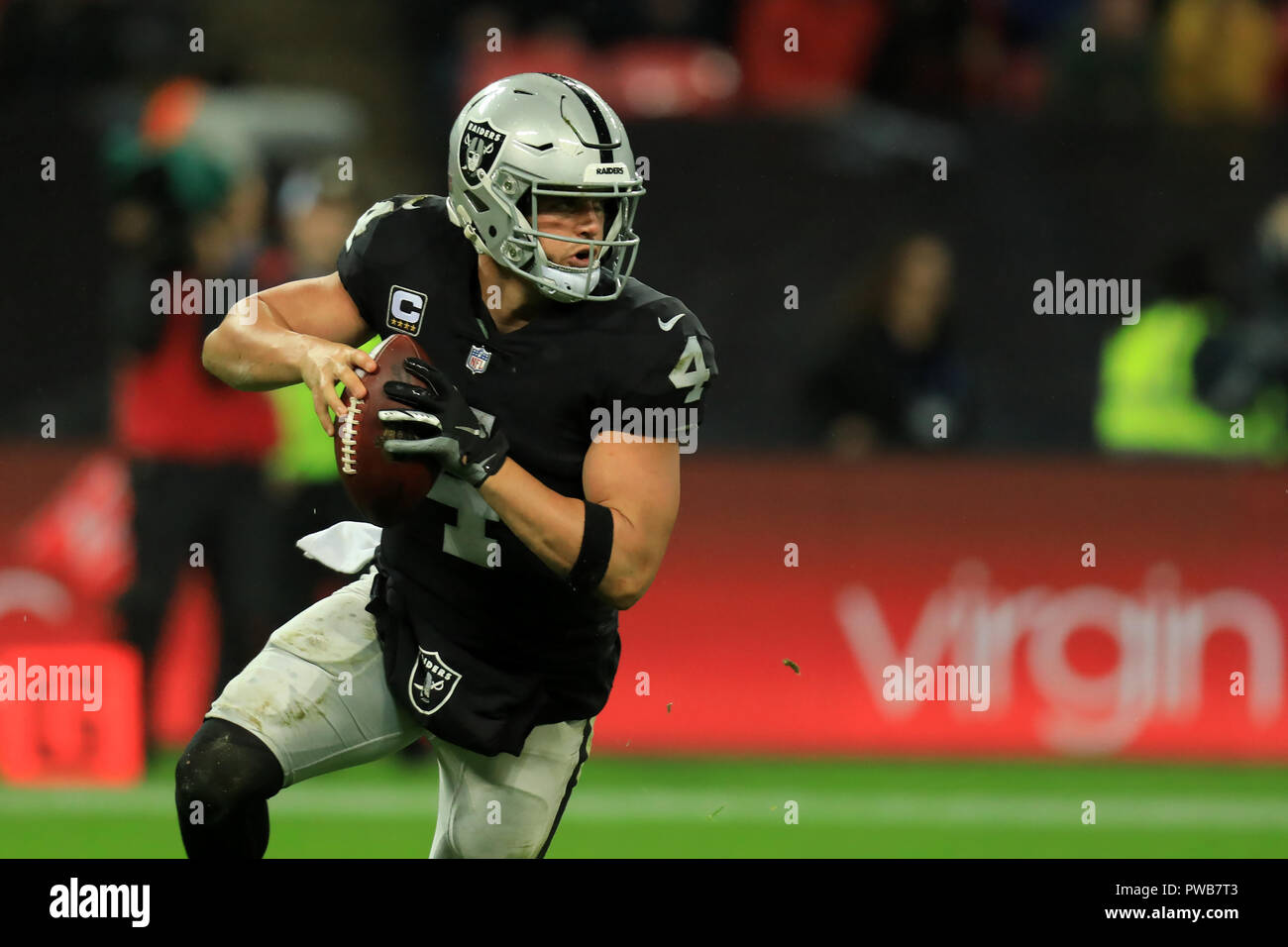 Wembley Stadium, London, UK. 14th Oct, 2018. NFL in London, game one, Seattle Seahawks versus Oakland Raiders; Quarterback Derek Carr of the Oakland Raiders drops back to throw upfield Credit: Action Plus Sports/Alamy Live News Stock Photo