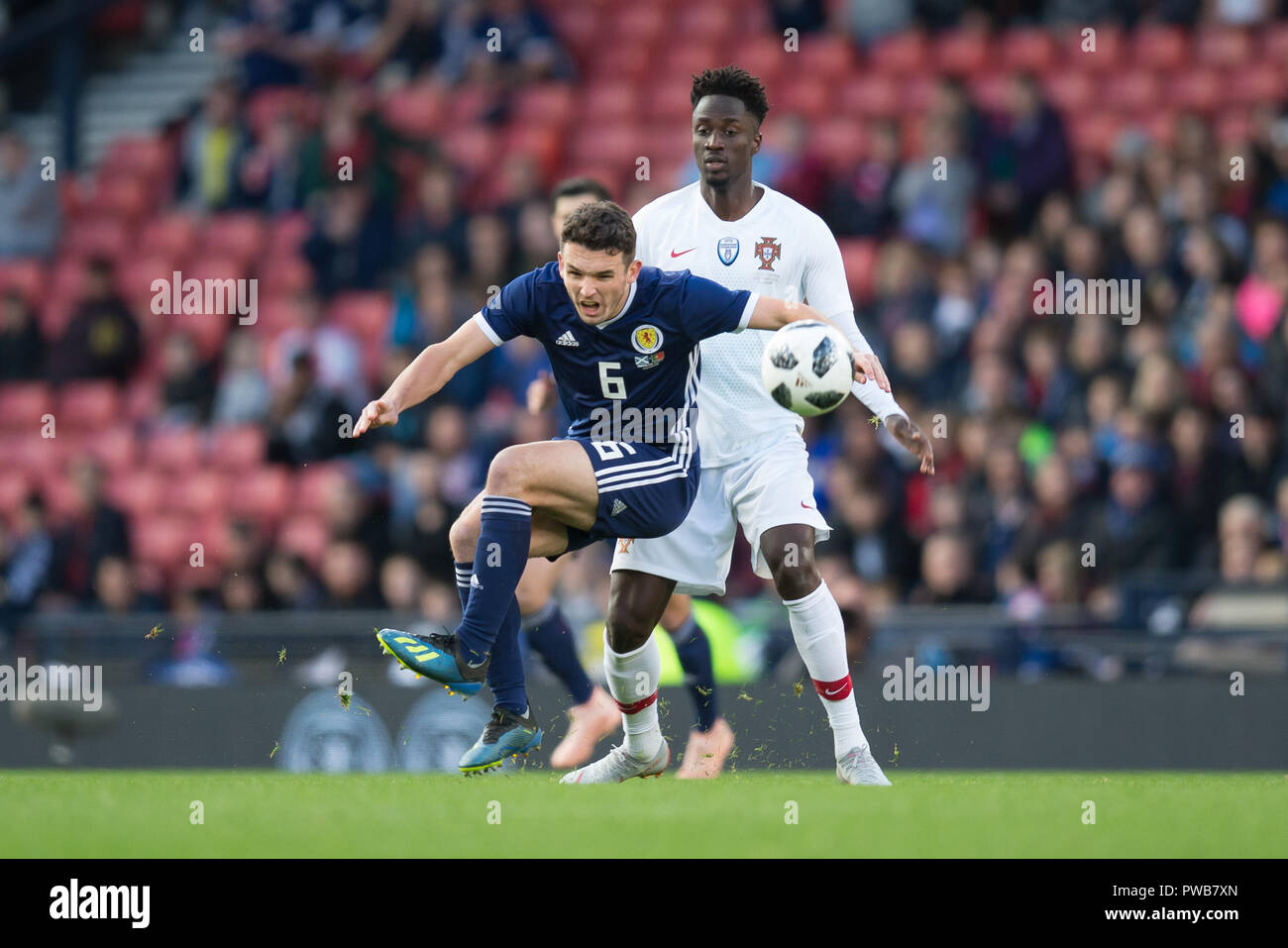 Hampden Park, Glasgow, UK. 14th Oct, 2018. International Football Friendly, Scotland versus Portugal; John McGinn of Scotland is tackled by Eder of Portugal Credit: Action Plus Sports/Alamy Live News Stock Photo