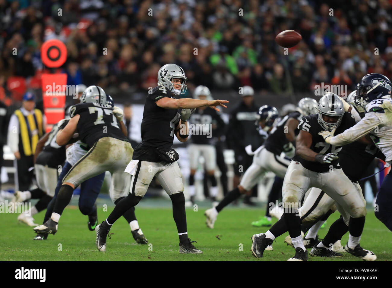 Wembley Stadium, London, UK. 14th Oct, 2018. NFL in London, game one, Seattle Seahawks versus Oakland Raiders; Quarterback Derek Carr of the Oakland Raiders throws the pass Credit: Action Plus Sports/Alamy Live News Stock Photo