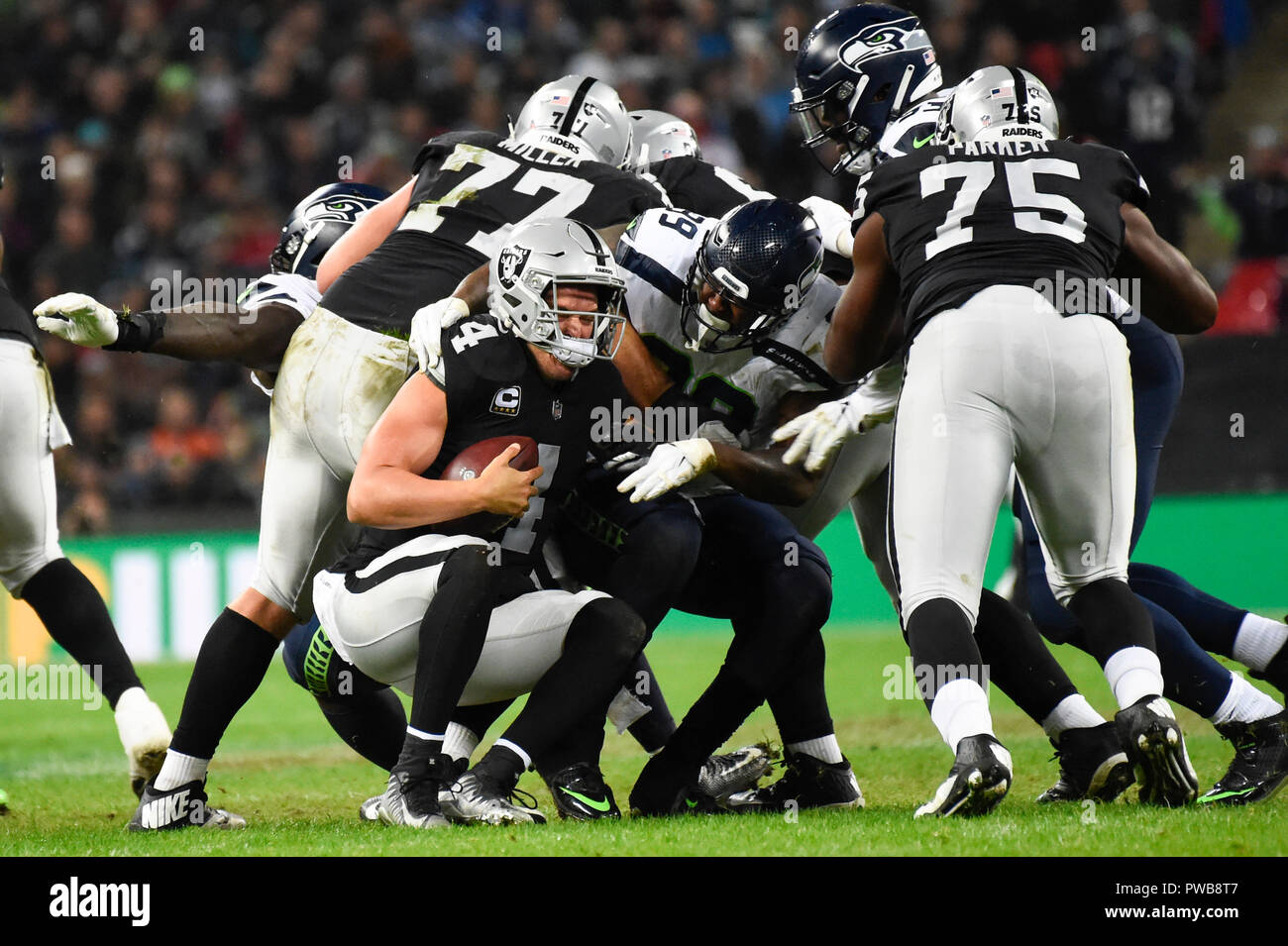 London, UK.  14 October 2018. Quarterback Derek Carr (4) of Oakland gets sacked. Seattle Seahawks at Oakland Raiders NFL game at Wembley Stadium, the first of the NFL London 2018 games. Final score Seahawks 27 Raiders 3.  Credit: Stephen Chung / Alamy Live News Stock Photo
