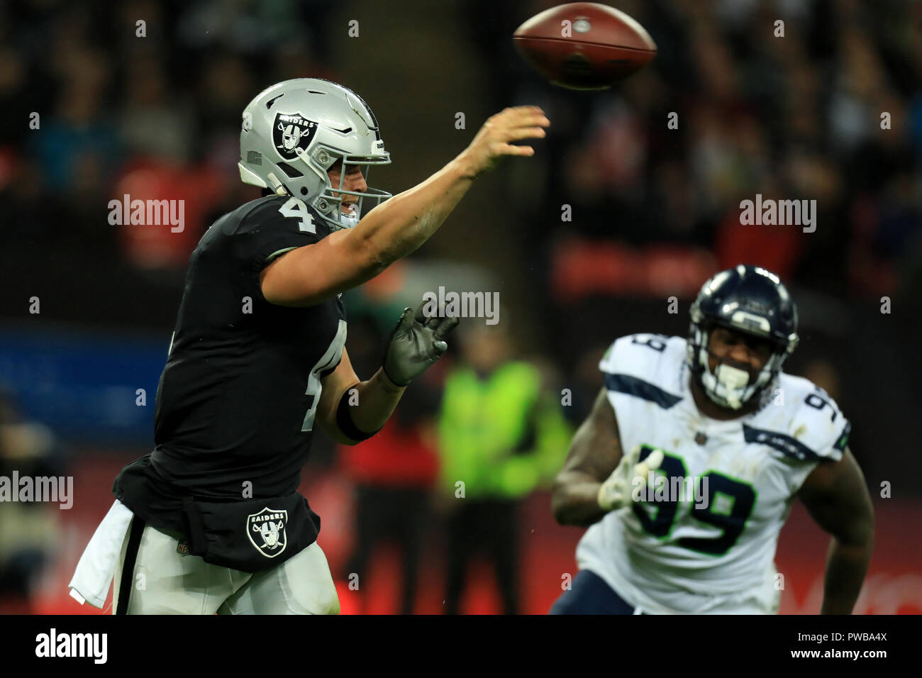 Wembley Stadium, London, UK. 14th Oct, 2018. NFL in London, game one, Seattle Seahawks versus Oakland Raiders; Quarterback Derek Carr of the Oakland Raiders throws the ball Credit: Action Plus Sports/Alamy Live News Stock Photo