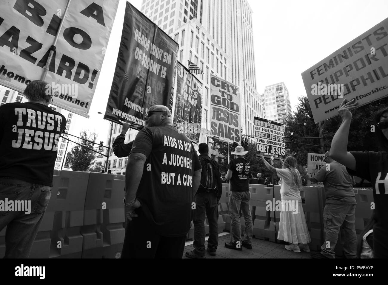 Atlanta, GA, USA. 14th Oct, 2018. Members of the Street and Open Air Preachers Association (SOAPA) gather to protest along route off Atlanta Gay Pride Parade. Members convene in Atlanta and other major cities with Gay Pride festivals to share scripture in their own style, which is often viewed at hate-filled and mean. This group was directed by Reuben Israel (Reuben Chavez) who has been labeled a cult leader by several organizations, including other pastors. Pictured: Reuben Israel directs his team Credit: Robin Rayne Nelson/ZUMA Wire/Alamy Live News Stock Photo