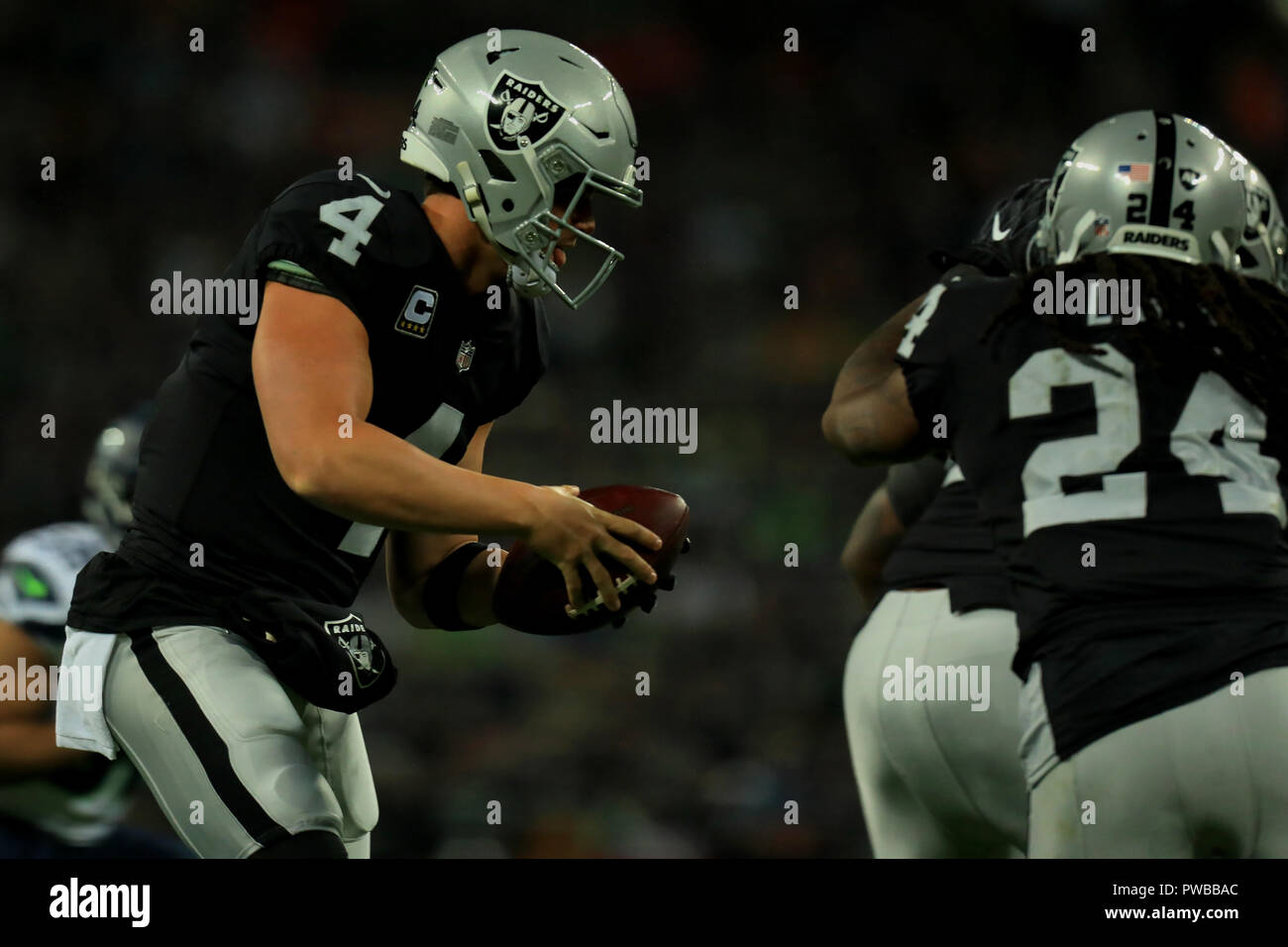 Wembley Stadium, London, UK. 14th Oct, 2018. NFL in London, game one, Seattle Seahawks versus Oakland Raiders; Quarterback Derek Carr of the Oakland Raiders is looking for the pass to Marshawn Lynch Credit: Action Plus Sports/Alamy Live News Stock Photo