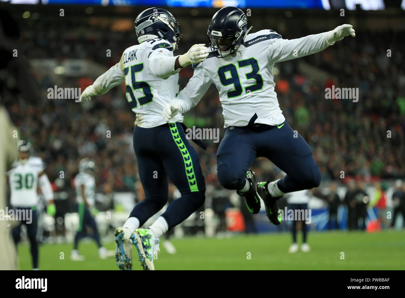 Wembley Stadium, London, UK. 14th Oct, 2018. NFL in London, game one, Seattle Seahawks versus Oakland Raiders; Branden Jackson of the Seattle Seahawks celebrates with Frank Clark for his sack on Quarterback Derek Carr of the Oakland Raiders Credit: Action Plus Sports/Alamy Live News Stock Photo