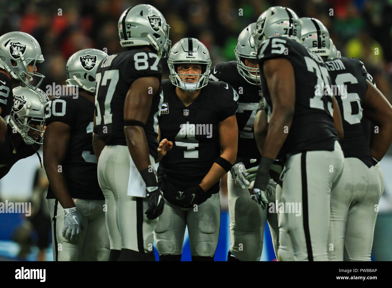Wembley Stadium, London, UK. 14th Oct, 2018. NFL in London, game one, Seattle Seahawks versus Oakland Raiders; Quarterback Derek Carr of the Oakland Raiders discusses the next play with his offensive line Credit: Action Plus Sports/Alamy Live News Stock Photo