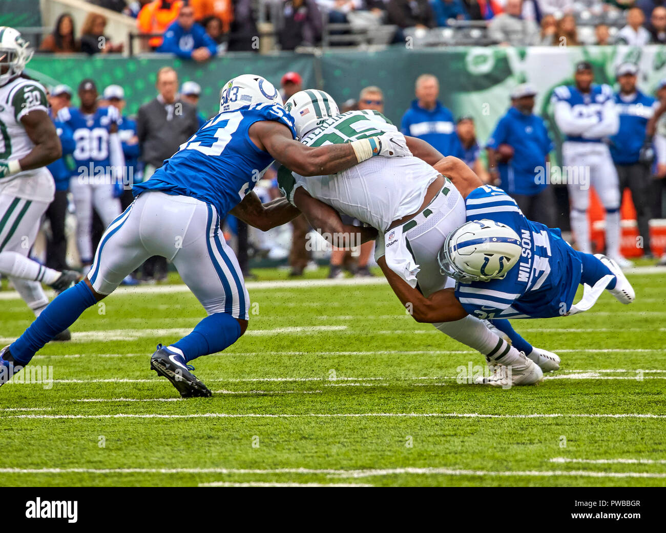 East Rutherford, New Jersey, USA. 14th Oct, 2018. New York Jets tight end Neal Sterling (85) is tackled by Indianapolis Colts linebacker Darius Leonard (53) and cornerback Quincy Wilson (31) during a NFL game between the Indianapolis Colts and the New York Jets at MetLife Stadium in East Rutherford, New Jersey. The Jets defeated the Colts 42-34. Duncan Williams/CSM/Alamy Live News Stock Photo