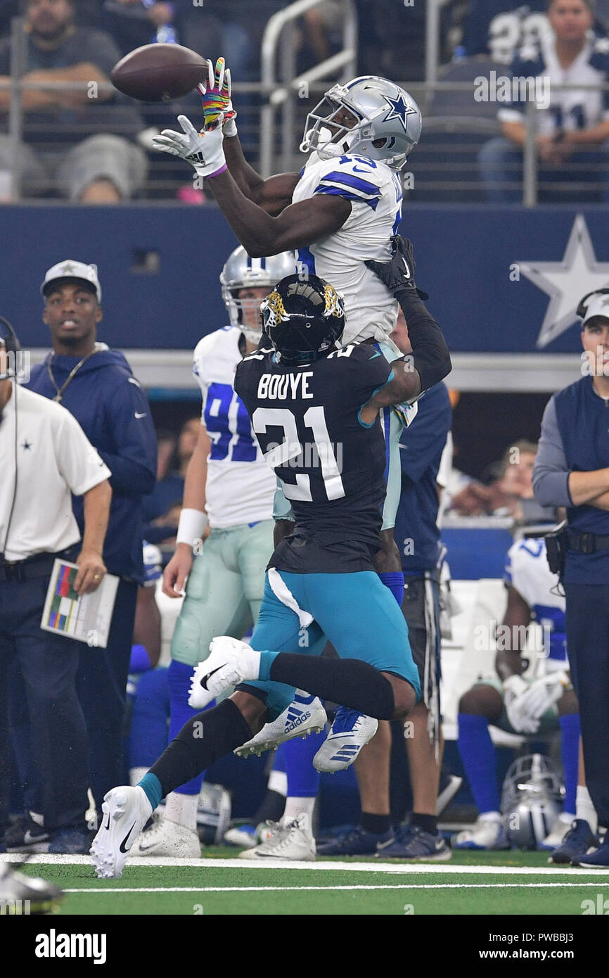 Arlington, Texas, USA. 14th Oct, 2018. Dallas Cowboys wide receiver Michael  Gallup (13) makes a catch with Jacksonville Jaguars cornerback A.J. Bouye  (21) trying to break it up during the first half