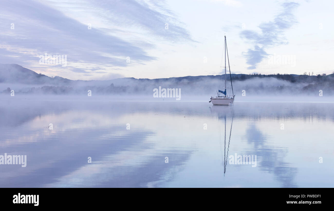 Lake Windermere, Ambleside, Cumbria, UK. 15th Oct, 2018. UK Weather. Clear skies during sunrise, but mist rises from the lake.  Photograph by Credit: Richard Holmes/Alamy Live News Stock Photo