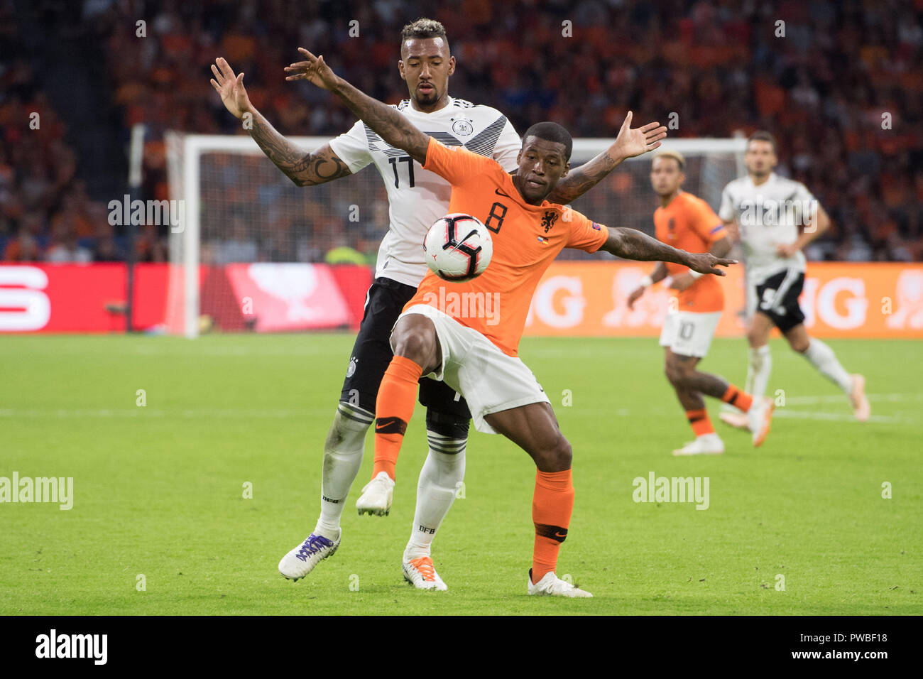 Jerome BOATENG (left, GER) versus Georginio WIJNALDUM (NED), action, duels, football Laender match, Nations League, Netherlands (NED) - Germany (GER) 3: 0, on 13.10.2018 in the Johan Cruyff Arena in Amsterdam/Netherlands. ¬ | usage worldwide Stock Photo