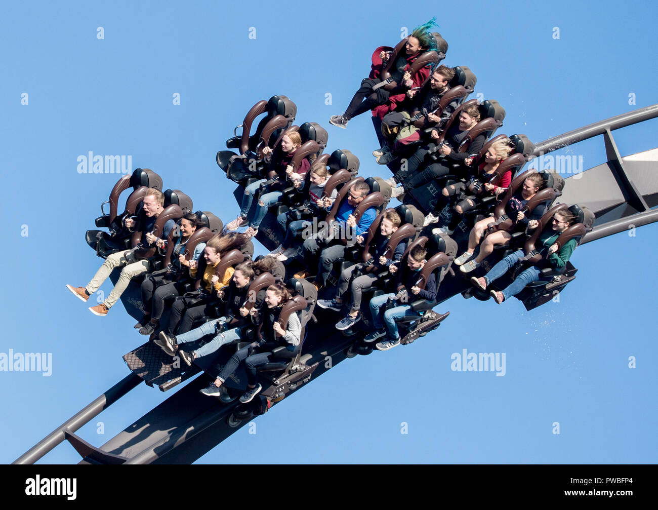 Soltau, Lower Saxony. 14th Oct, 2018. Visitors ride the roller coaster " Krake" in Heide-Park. The so-called Dive Coaster was put into operation in  2011. Credit: Hauke-Christian Dittrich/dpa/Alamy Live News Stock Photo -