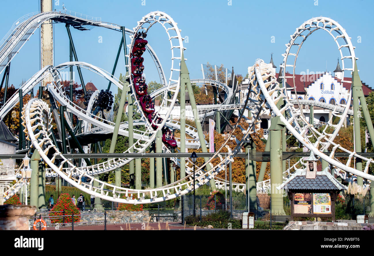 Soltau, Lower Saxony. 14th Oct, 2018. Visitors ride the roller coaster "Big Loop" in HeidePark