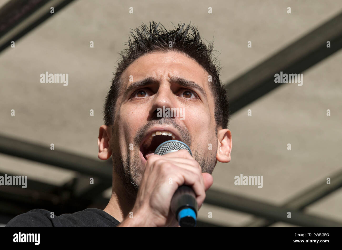 London, Greater London, UK. 13th Oct, 2018. Yannis Gourtsoyannis, Momentum NEC & leading junior activist in the BMA speaking at the antifascist demonstration against the DFLA in London.Counter demonstration organised by United Against Racism & Islamophobia, Trade Unions and Stand Up to Racism marched from Old Palace Yard to Whitehall in an attempt to block the route of Democratic Football Lads Alliance (DFLA) march in London. During the counter demonstration there were incidents where DFLA supporters attempted to get close to the anti-racist protesters, that were controlled by Stock Photo