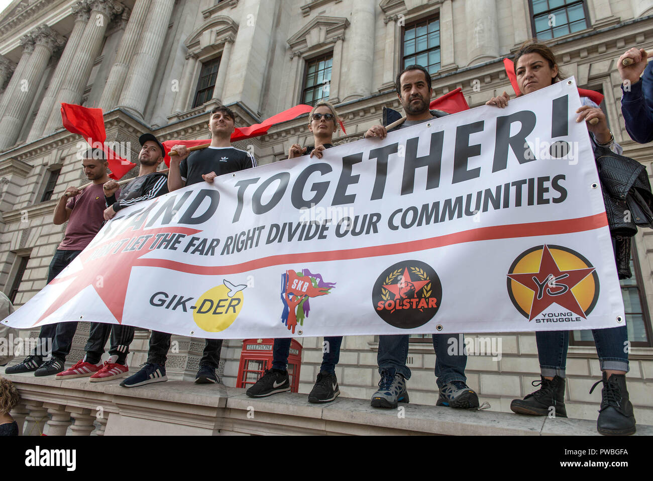 London, Greater London, UK. 13th Oct, 2018. Protesters seen holding a banner and flags at the antifascist demonstration against the DFLA in London.Counter demonstration organised by United Against Racism & Islamophobia, Trade Unions and Stand Up to Racism marched from Old Palace Yard to Whitehall in an attempt to block the route of Democratic Football Lads Alliance (DFLA) march in London. During the counter demonstration there were incidents where DFLA supporters attempted to get close to the anti-racist protesters, that were controlled by the police. (Credit Image: © Andres P Stock Photo