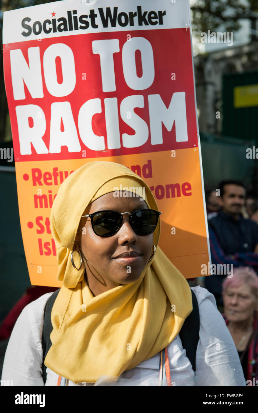 London, Greater London, UK. 13th Oct, 2018. A protester holding an antiracism banner at the antifascist demonstration against the DFLA in London.Counter demonstration organised by United Against Racism & Islamophobia, Trade Unions and Stand Up to Racism marched from Old Palace Yard to Whitehall in an attempt to block the route of Democratic Football Lads Alliance (DFLA) march in London. During the counter demonstration there were incidents where DFLA supporters attempted to get close to the anti-racist protesters, that were controlled by the police. (Credit Image: © Andres Pan Stock Photo