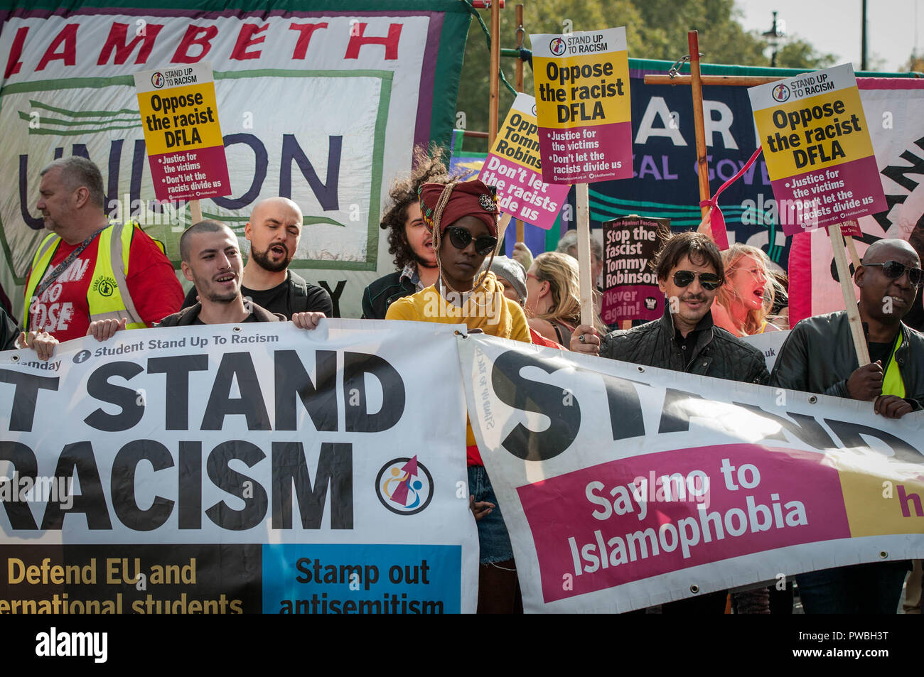 People marching to Whitehall holding banners and placards during the antifascist demonstration against the DFLA in London. Counter demonstration organised by United Against Racism & Islamophobia, Trade Unions and Stand Up to Racism marched from Old Palace Yard to Whitehall in an attempt to block the route of Democratic Football Lads Alliance (DFLA) march in London. During the counter demonstration there were incidents where DFLA supporters attempted to get close to the anti-racist protesters, that were controlled by the police. Stock Photo