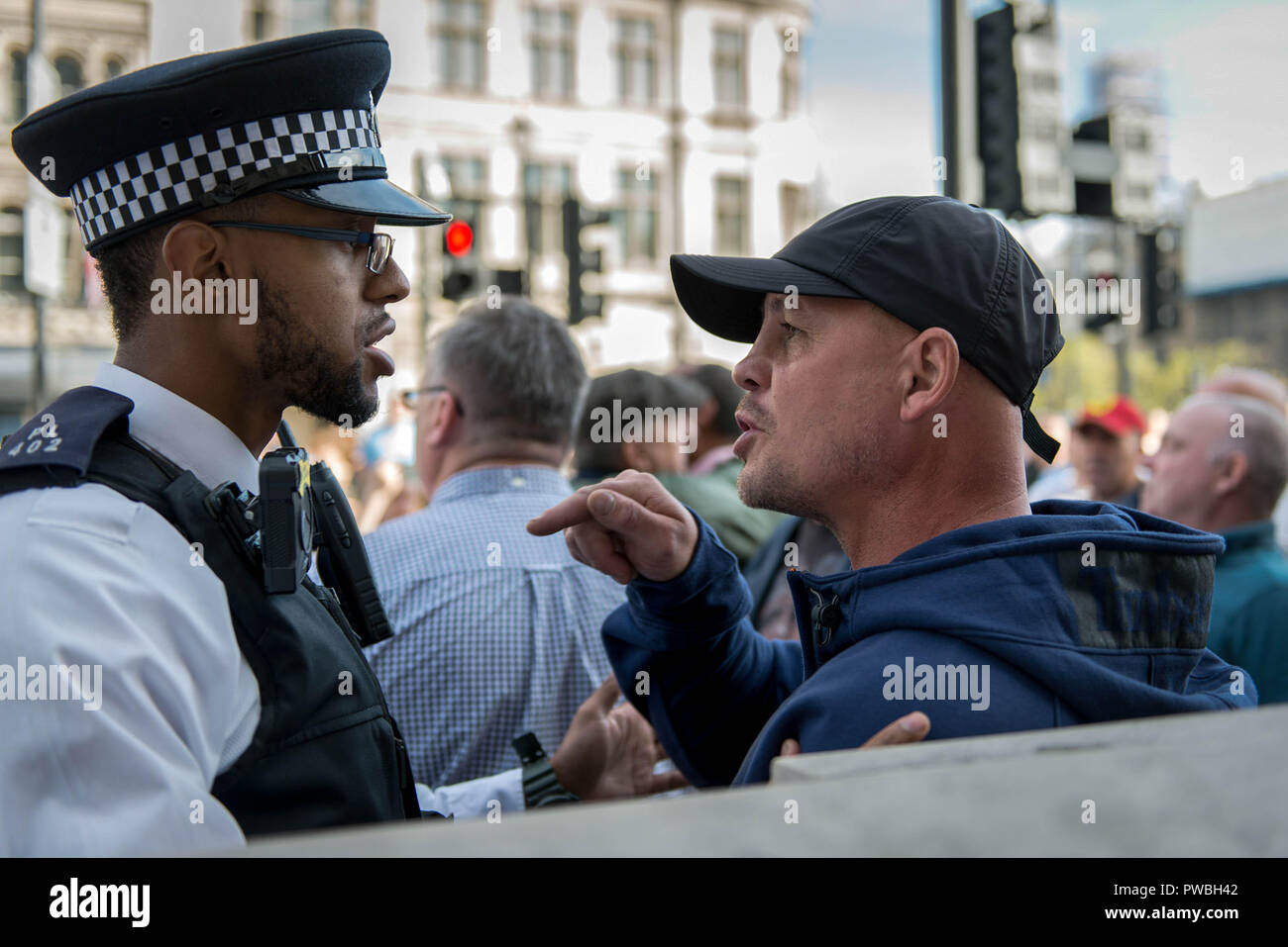 Supporters of the Football Lads Alliance (DFLA) clash with police as they attempt to get close to the antifascist demonstration against the DFLA in London. Counter demonstration organised by United Against Racism & Islamophobia, Trade Unions and Stand Up to Racism marched from Old Palace Yard to Whitehall in an attempt to block the route of Democratic Football Lads Alliance (DFLA) march in London. During the counter demonstration there were incidents where DFLA supporters attempted to get close to the anti-racist protesters, that were controlled by the police. Stock Photo