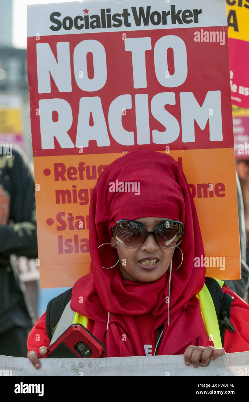 A protester holding an antiracism banner at the antifascist demonstration against the DFLA in London. Counter demonstration organised by United Against Racism & Islamophobia, Trade Unions and Stand Up to Racism marched from Old Palace Yard to Whitehall in an attempt to block the route of Democratic Football Lads Alliance (DFLA) march in London. During the counter demonstration there were incidents where DFLA supporters attempted to get close to the anti-racist protesters, that were controlled by the police. Stock Photo