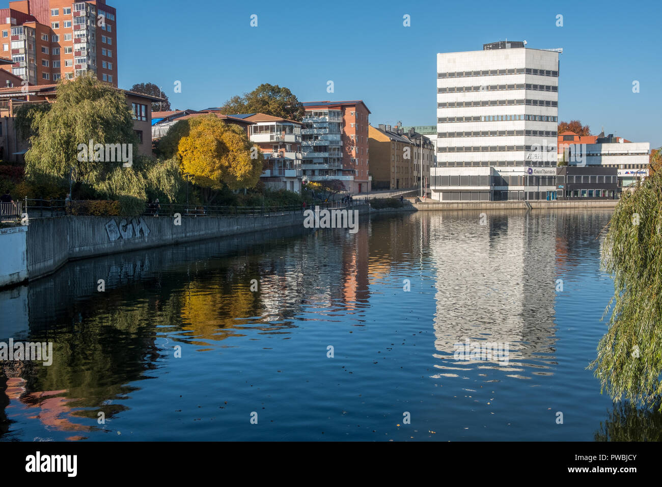 Norrköping waterfront and Motala stream during a warm and sunny autumn day. Norrkoping is a historic industrial town in Sweden. Stock Photo
