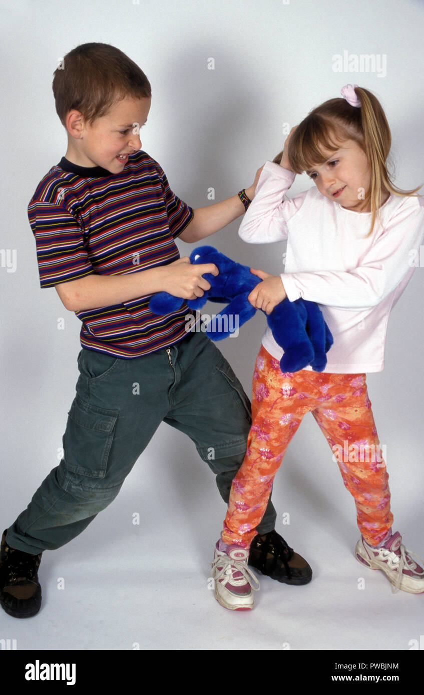 brother & sister fighting over a toy Stock Photo