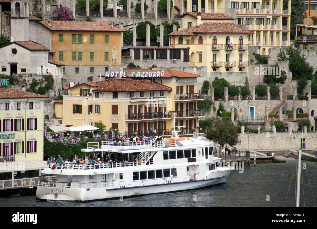 Peolple boarding a ferryboat outsde the Azzurro hotel Limone sol Garda Lake Garda Italy Stock Photo