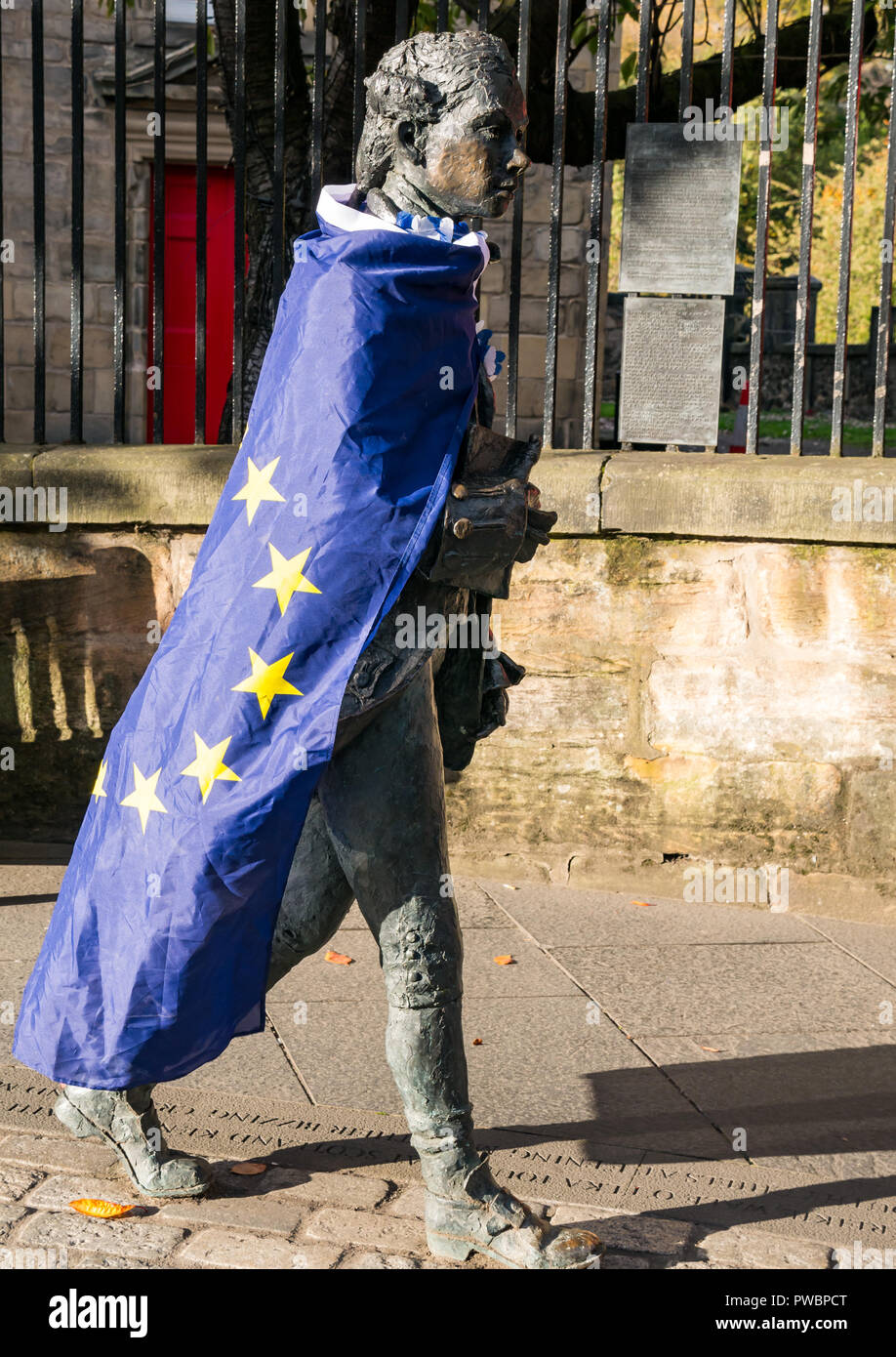 Poet Robert Fergusson statue draped in EU stars flag and yes independence sticker after AUOB march, Canongate, Royal Mile, Edinburgh, Scotland, UK Stock Photo