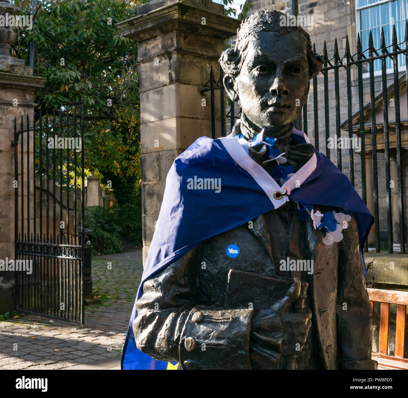 Poet Robert Fergusson statue draped in EU stars flag and yes independence sticker after AUOB march, Canongate, Royal Mile, Edinburgh, Scotland, UK Stock Photo