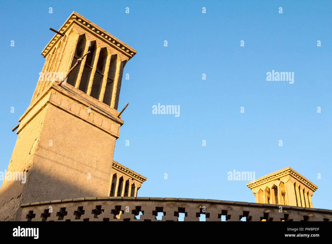 typical Windtower made of clay taken in the streets of Yazd, iran. These towers, aimed at cooling down buildings in the desert, are an icon of the Per Stock Photo
