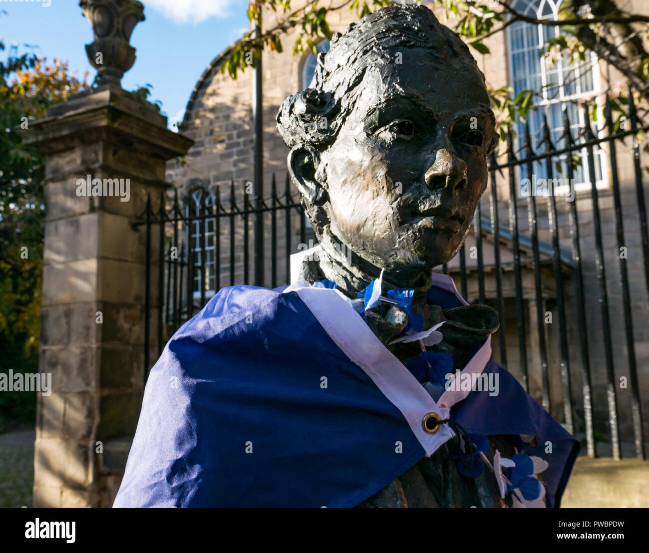 Poet Robert Fergusson statue draped in EU stars flag and yes independence sticker after AUOB march, Canongate, Royal Mile, Edinburgh, Scotland, UK Stock Photo