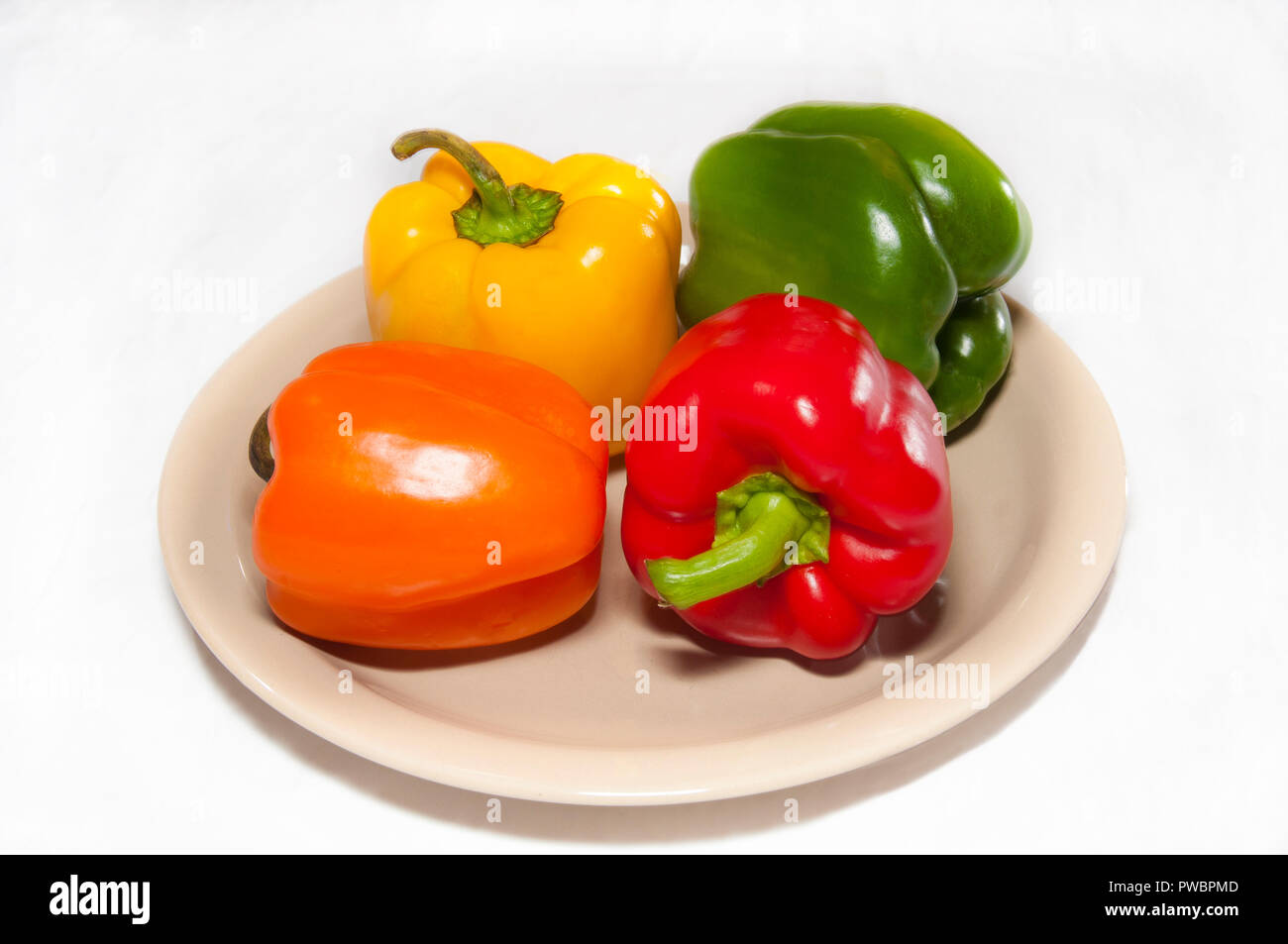Colorful on peppers on plate in white background Stock Photo