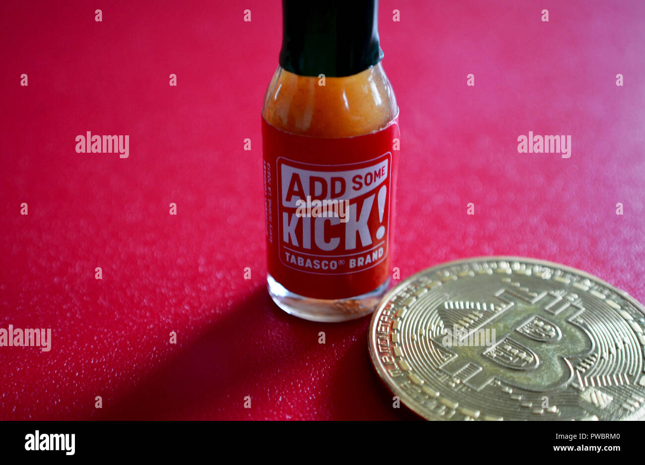 Bitcoin with Tabasco sauce bottle Stock Photo