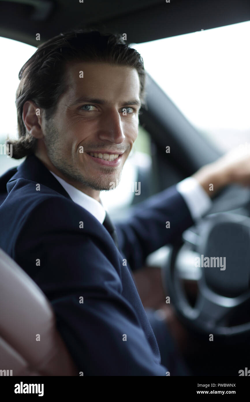 man sitting behind the wheel of a car Stock Photo - Alamy