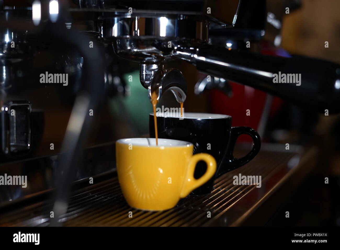 Barista making coffee using a coffee maker Stock Photo Alamy